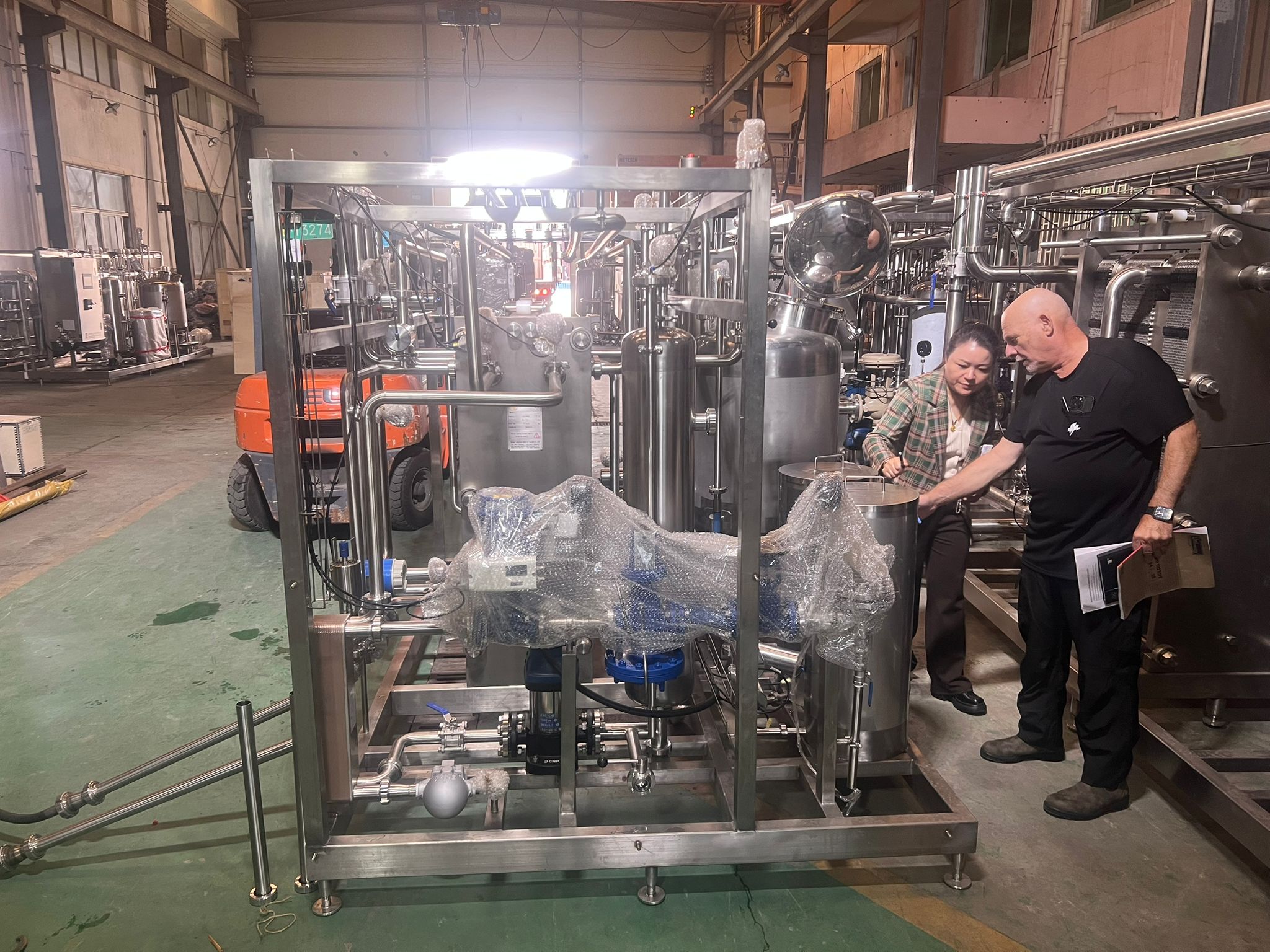 Stressed factory manager looking at aging equipment